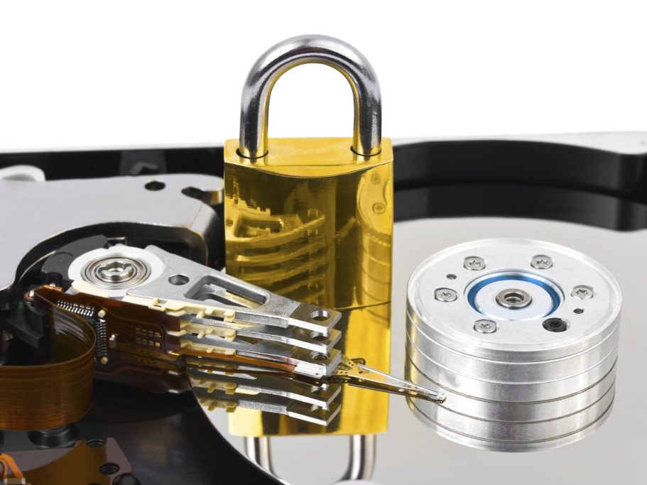 data security A close-up of a hard drive with a brass padlock on it.