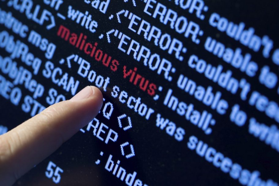 virus alert A finger pointing at error messages on a computer screen, highlighting "malicious virus."
